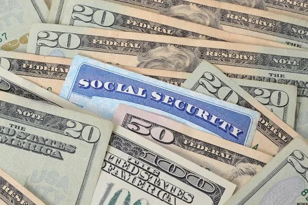social security card in pile of money 600x400 1  56203e8912487